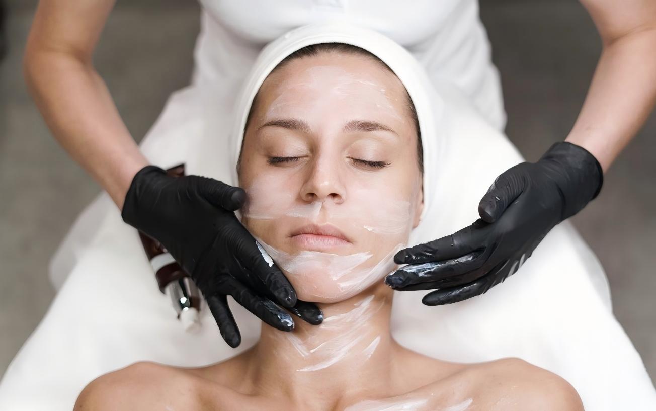 Skincare products and treatment tools in a bright, serene facial spa